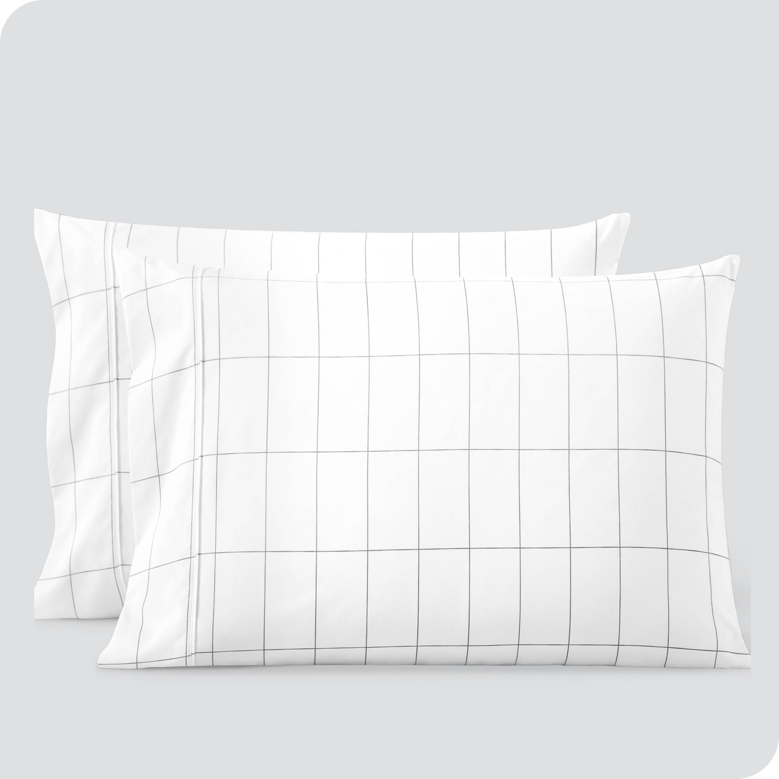 Two pillowcases on a white background with print pillowcases on them.