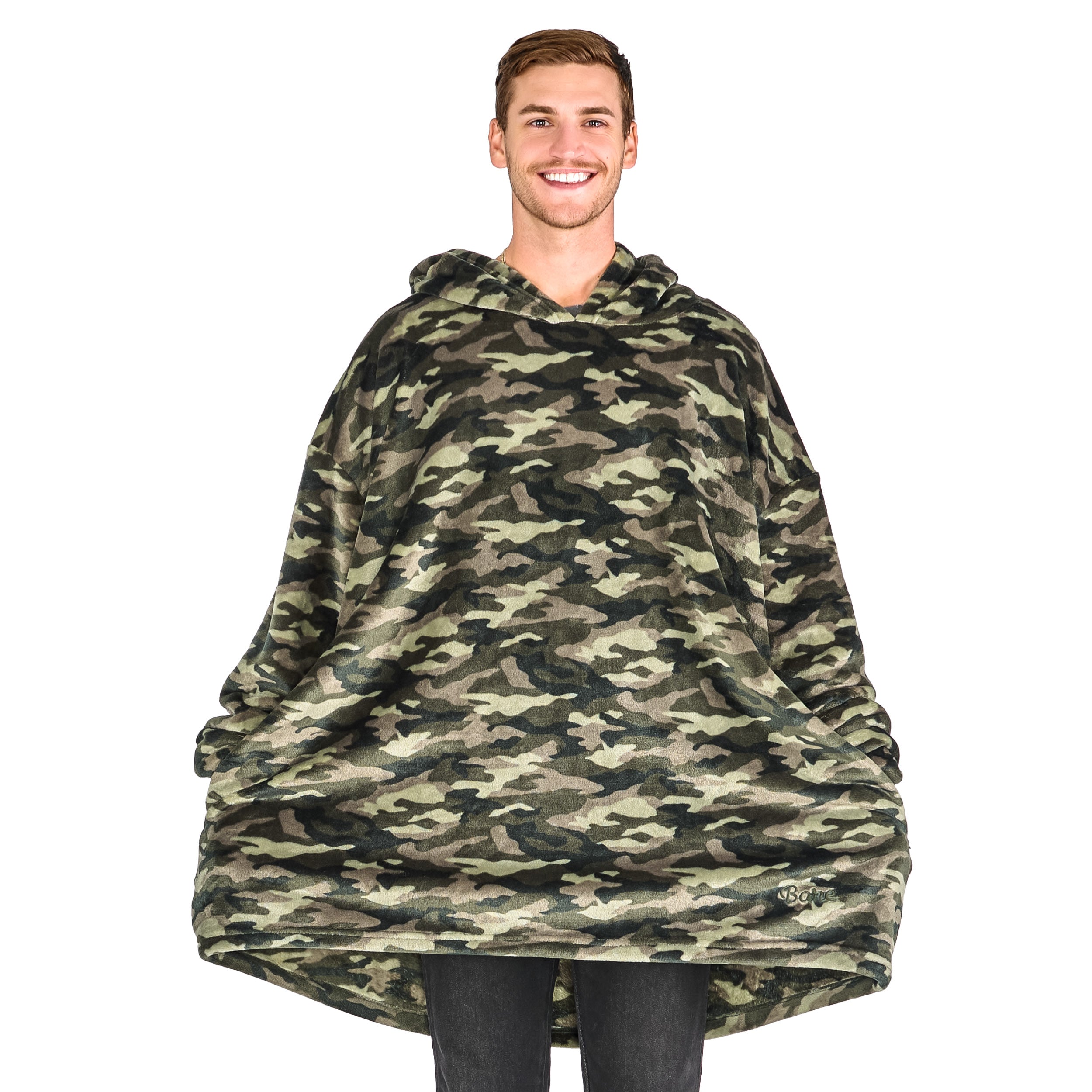 A smiling man has a wearable blanket on