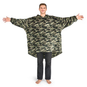 A man is standing with his arms stretched out while dressed in a wearable blanket