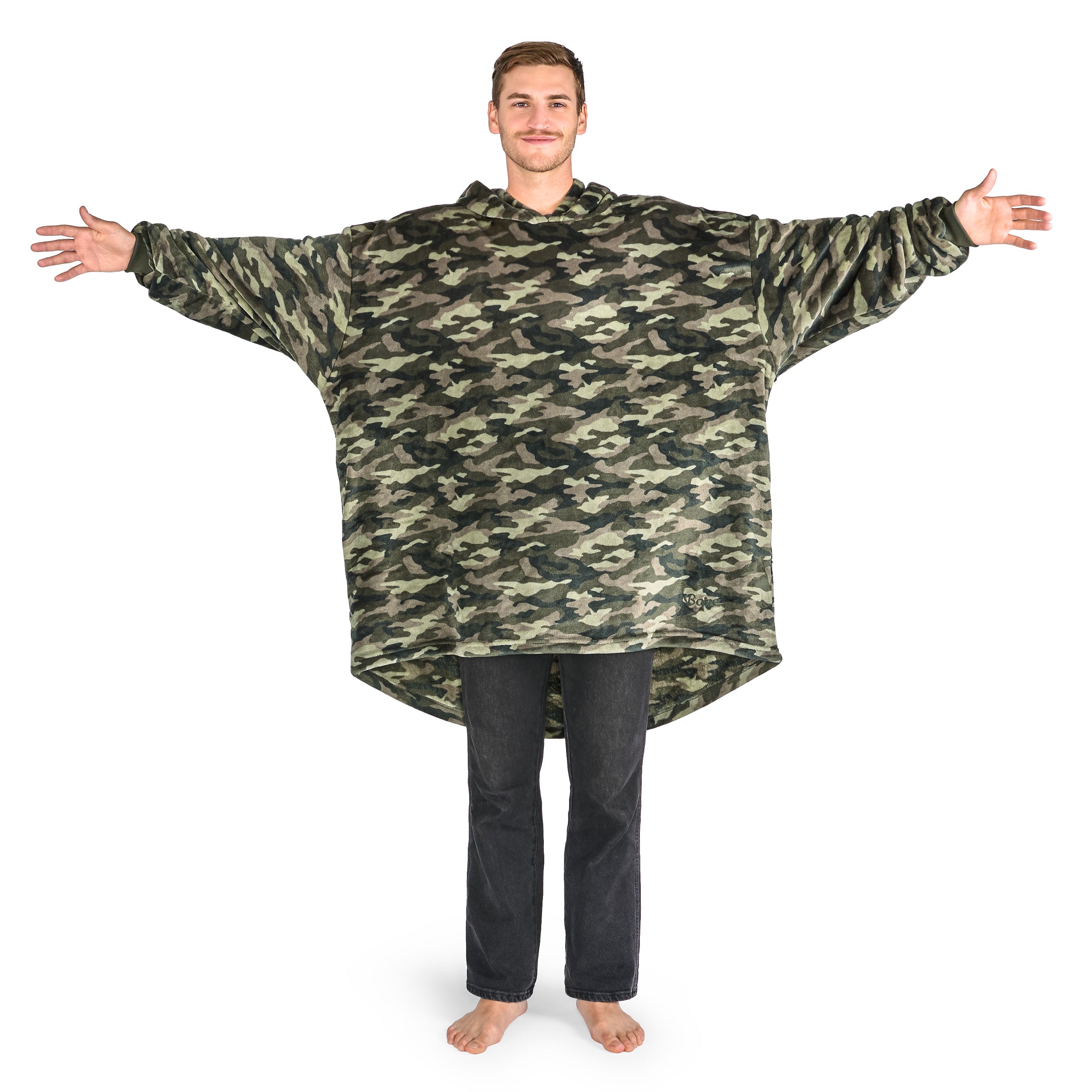 A man is standing with his arms stretched out while dressed in a wearable blanket