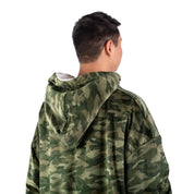 An adult with a sherpa wearable blanket on