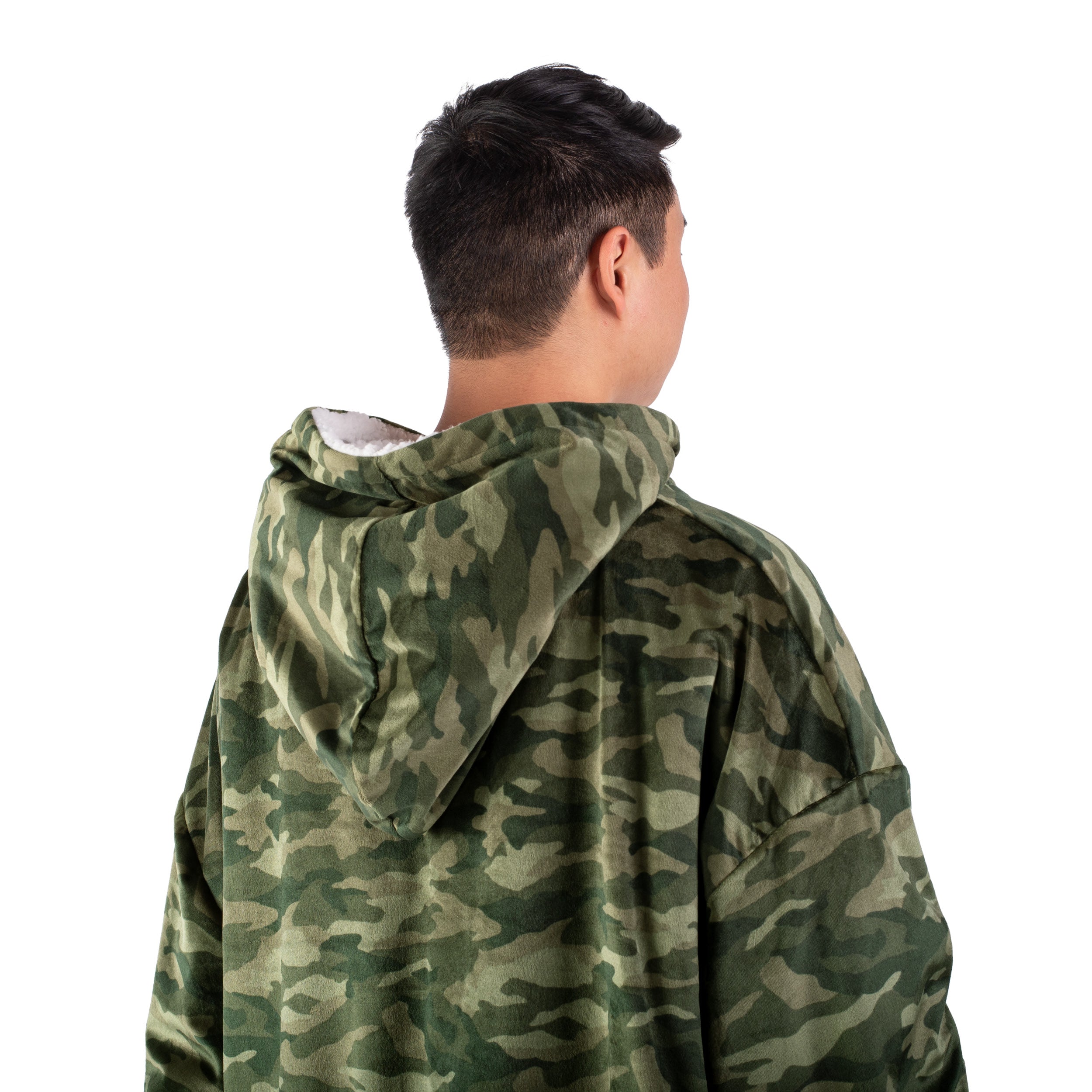 An adult with a sherpa wearable blanket on