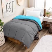 Wooden bed frame with a reversible comforter on the bed. The comforter is folded back over showing the two different colors.