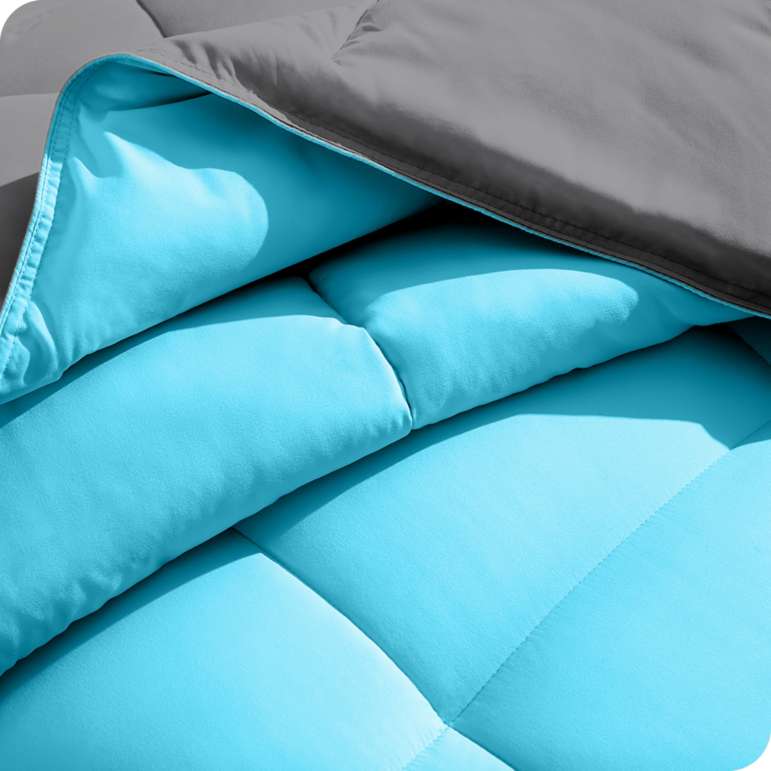Close up of the comforter folded back showing the two different colored sides.