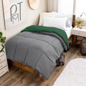 Wooden bed frame with a reversible comforter on the bed. The comforter is folded back over showing the two different colors.