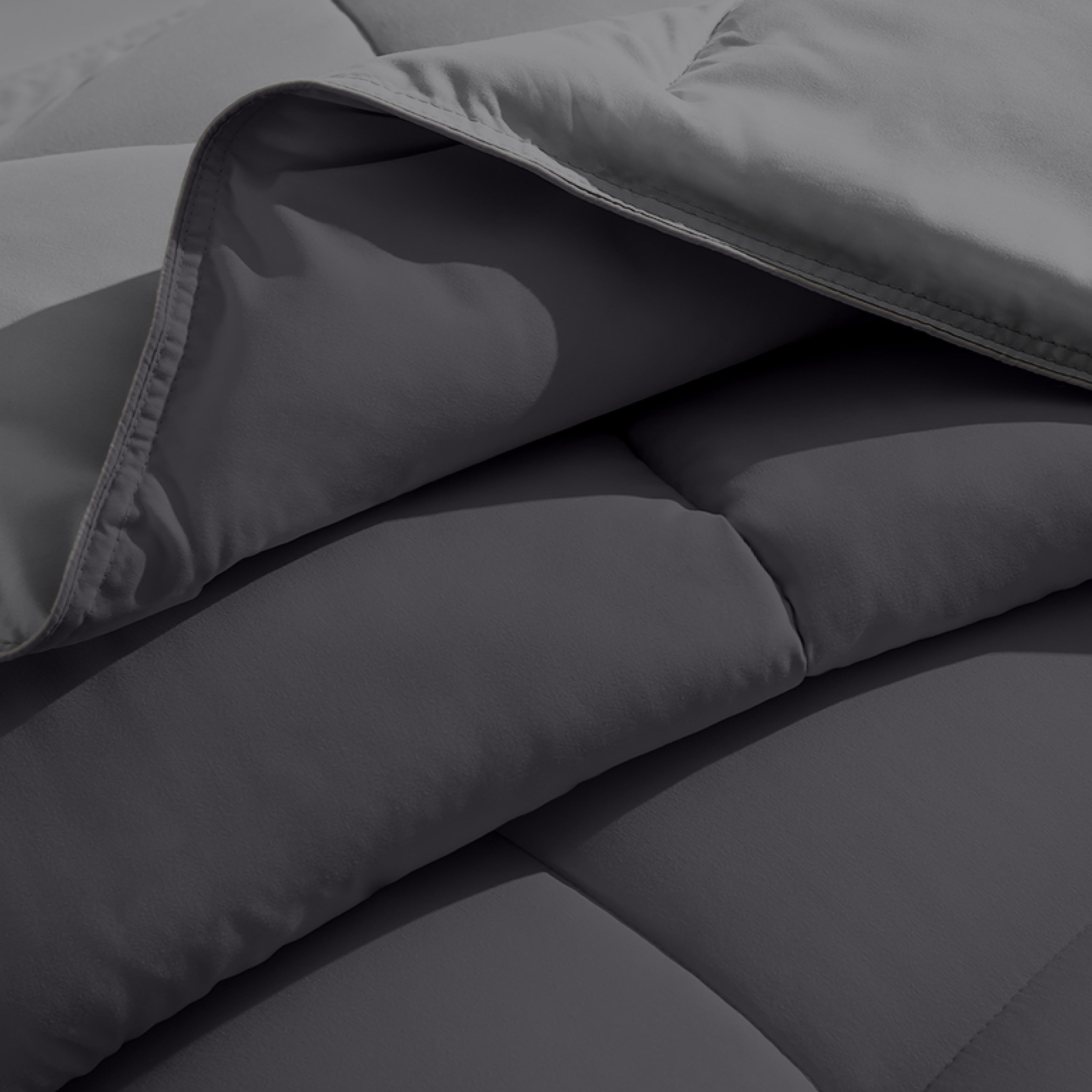 Close up of the reversible comforter showing the box stitching and the two colors