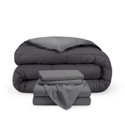 A reversible microfiber comforter and a coordinating sheet set folded and stacked 