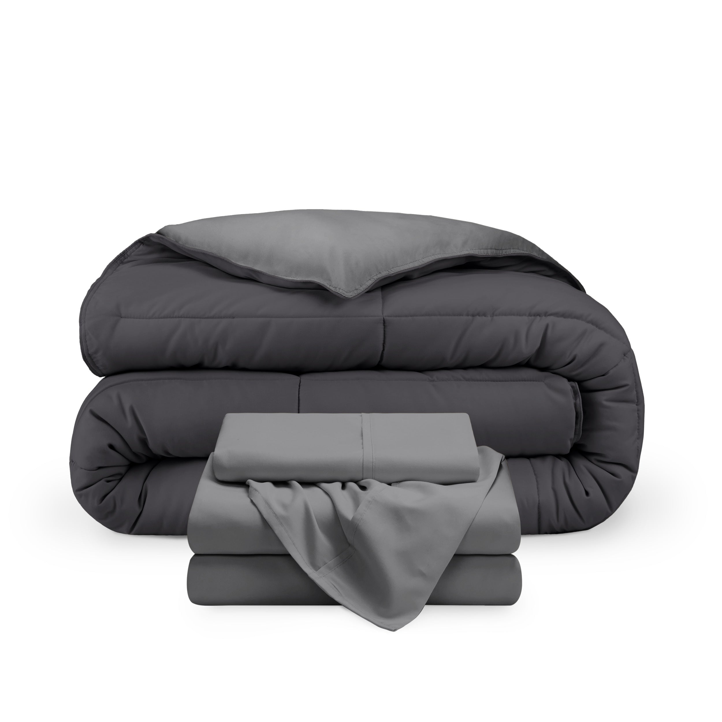 A reversible microfiber comforter and a coordinating sheet set folded and stacked 