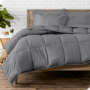 A wooden bed frame with sheets, pillow shams and a comforter on the bed