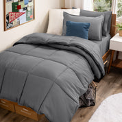A college dorm room with a bed in a bag set on the mattress