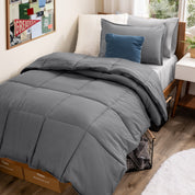 A college dorm room with a bed in a bag set on the mattress