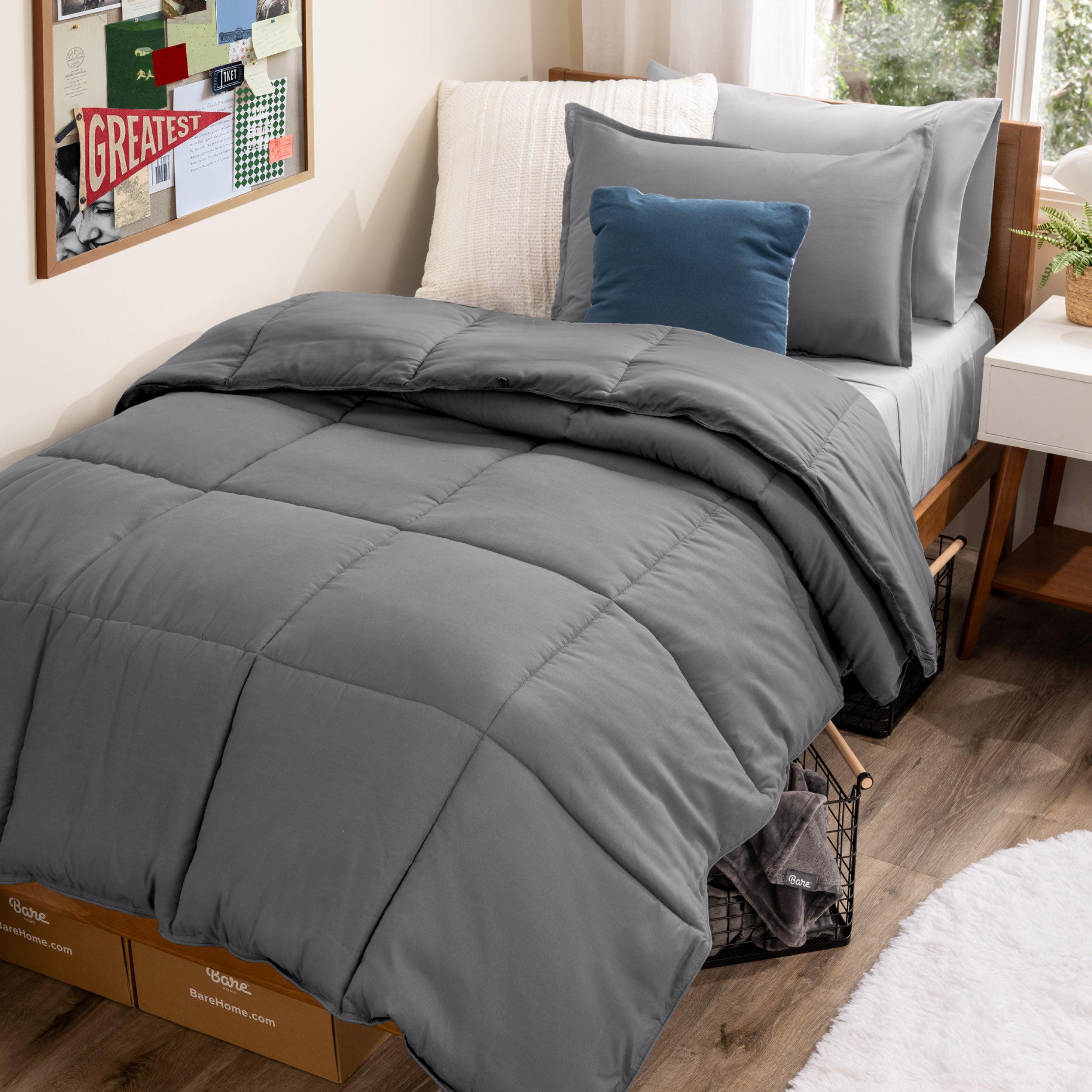 A college dorm room with a bed in a bag set on the mattress