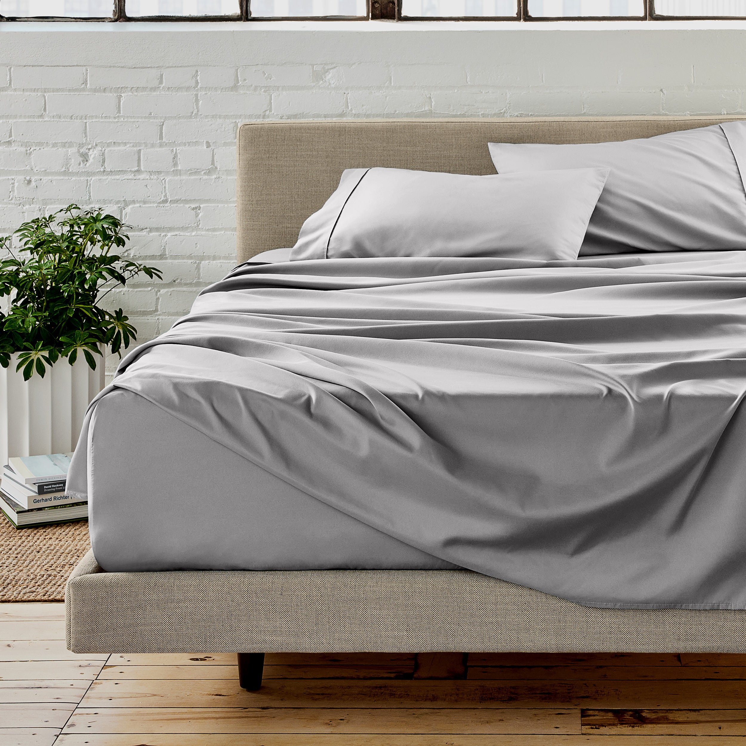 Microfiber sheet set on a bed with a white brick wall in the background