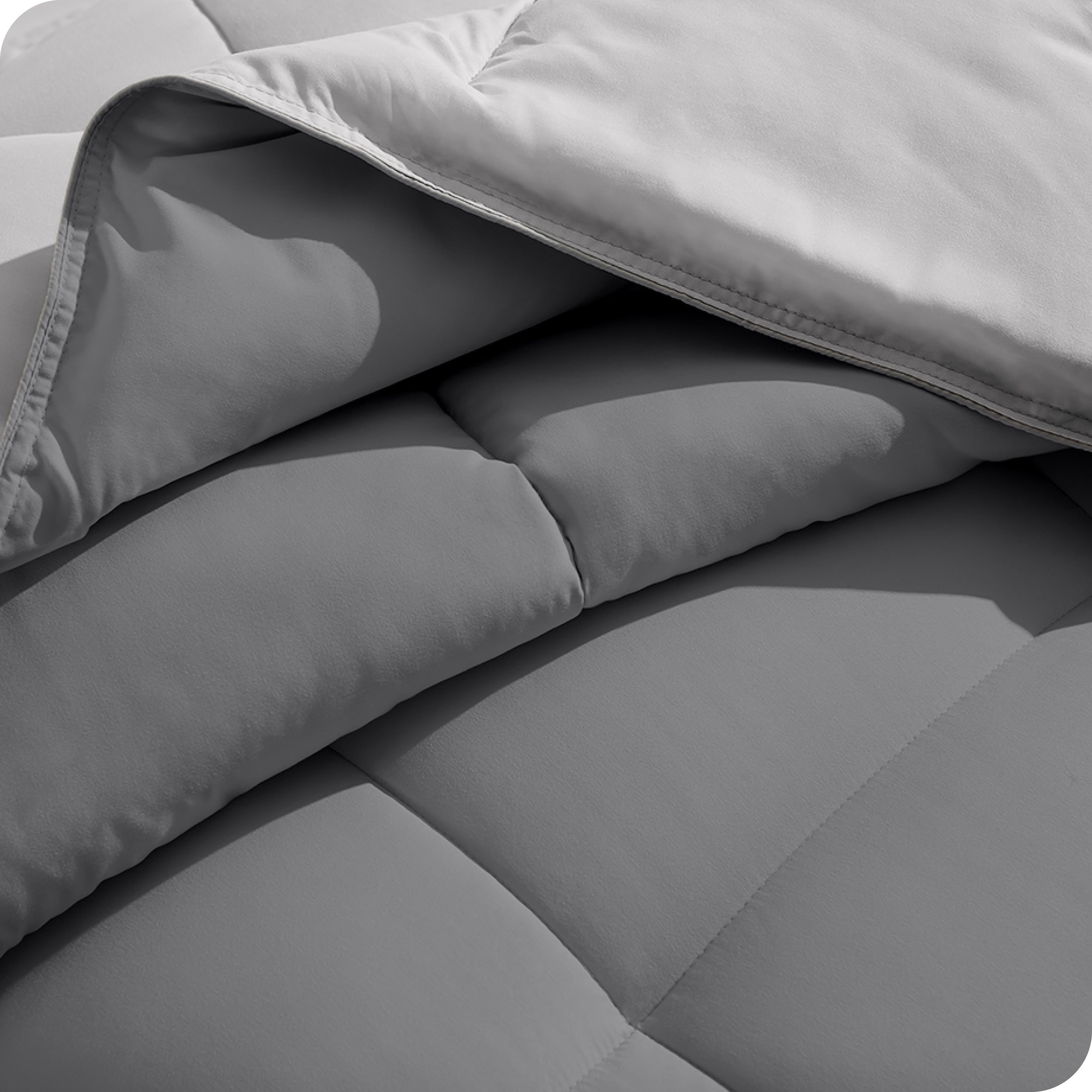 Close up of the comforter folded back showing the two different colored sides.