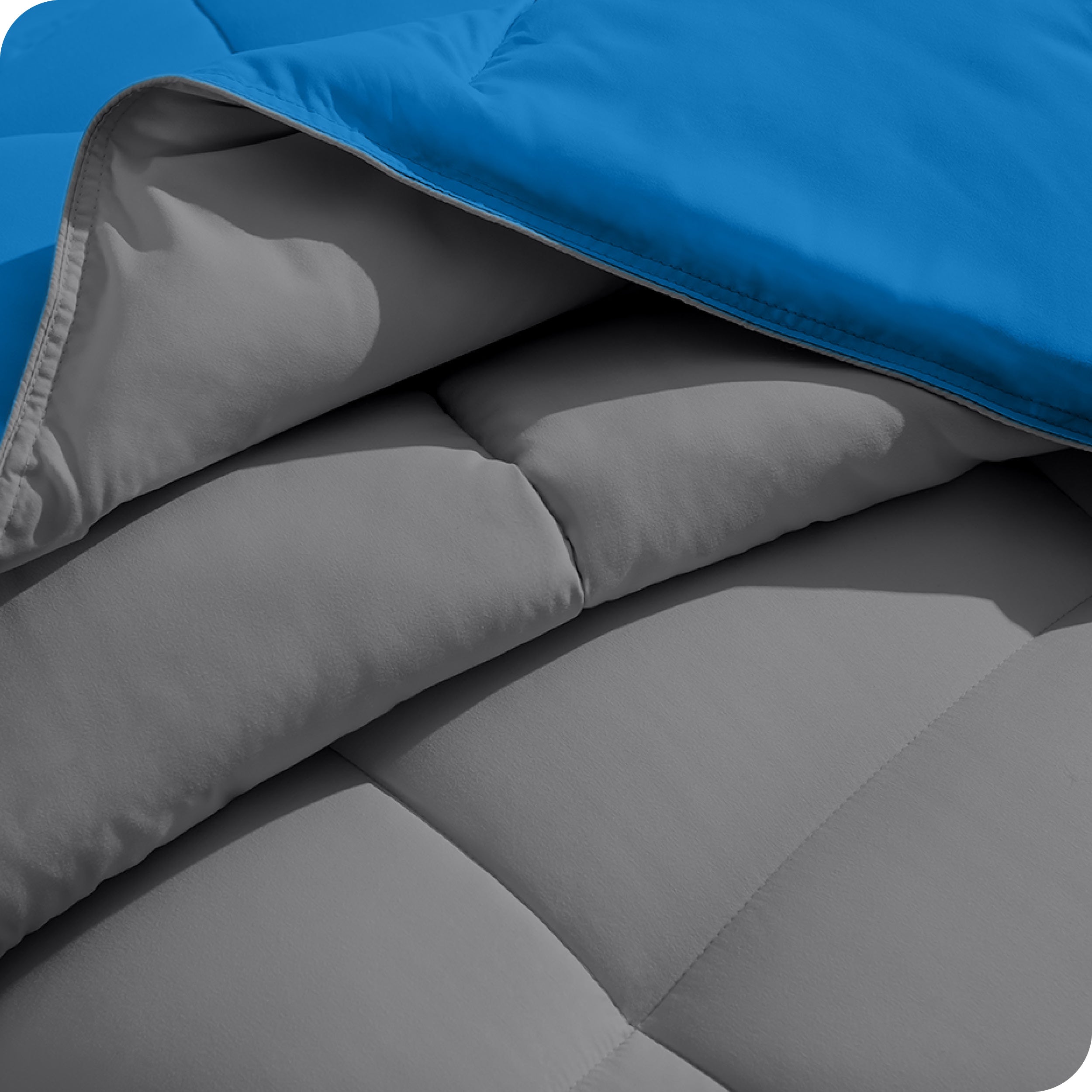 Close up of the comforter folded back showing the two different colored sides.