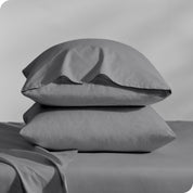 2 percale pillowcases on pillows set on a bed with matching sheets