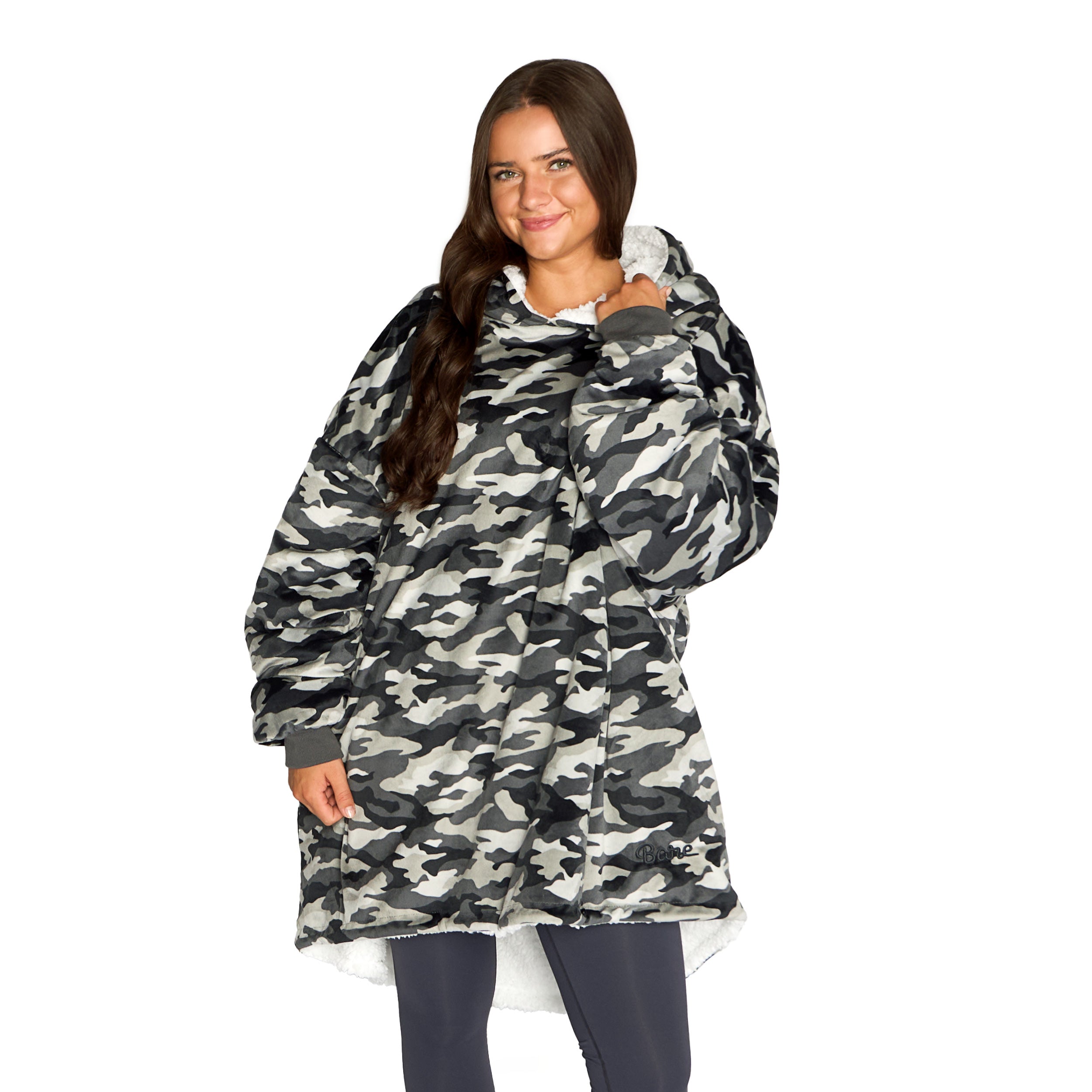 An adult with a sherpa wearable blanket on
