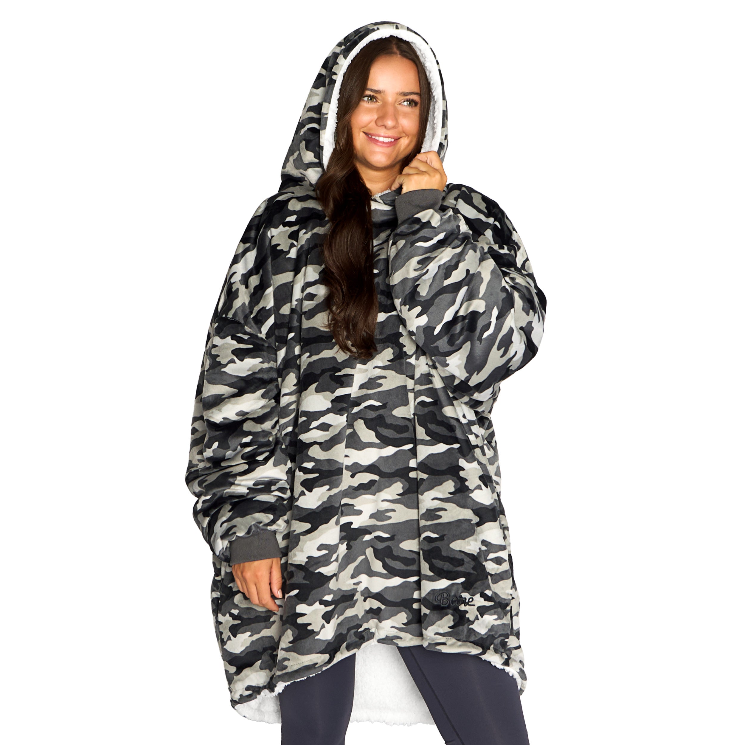 An adult with a sherpa wearable blanket on