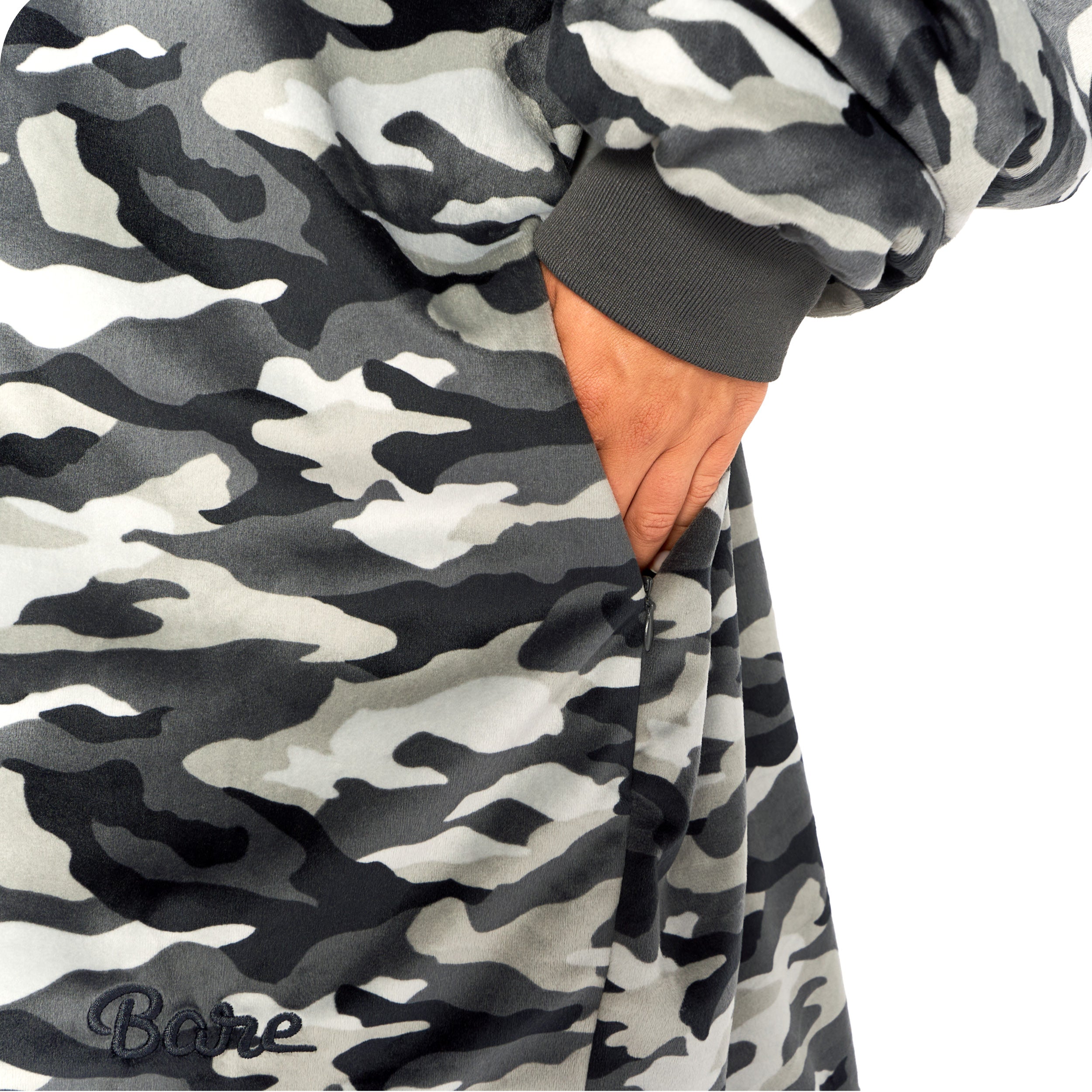 An adult with a hooded wearable blanket on