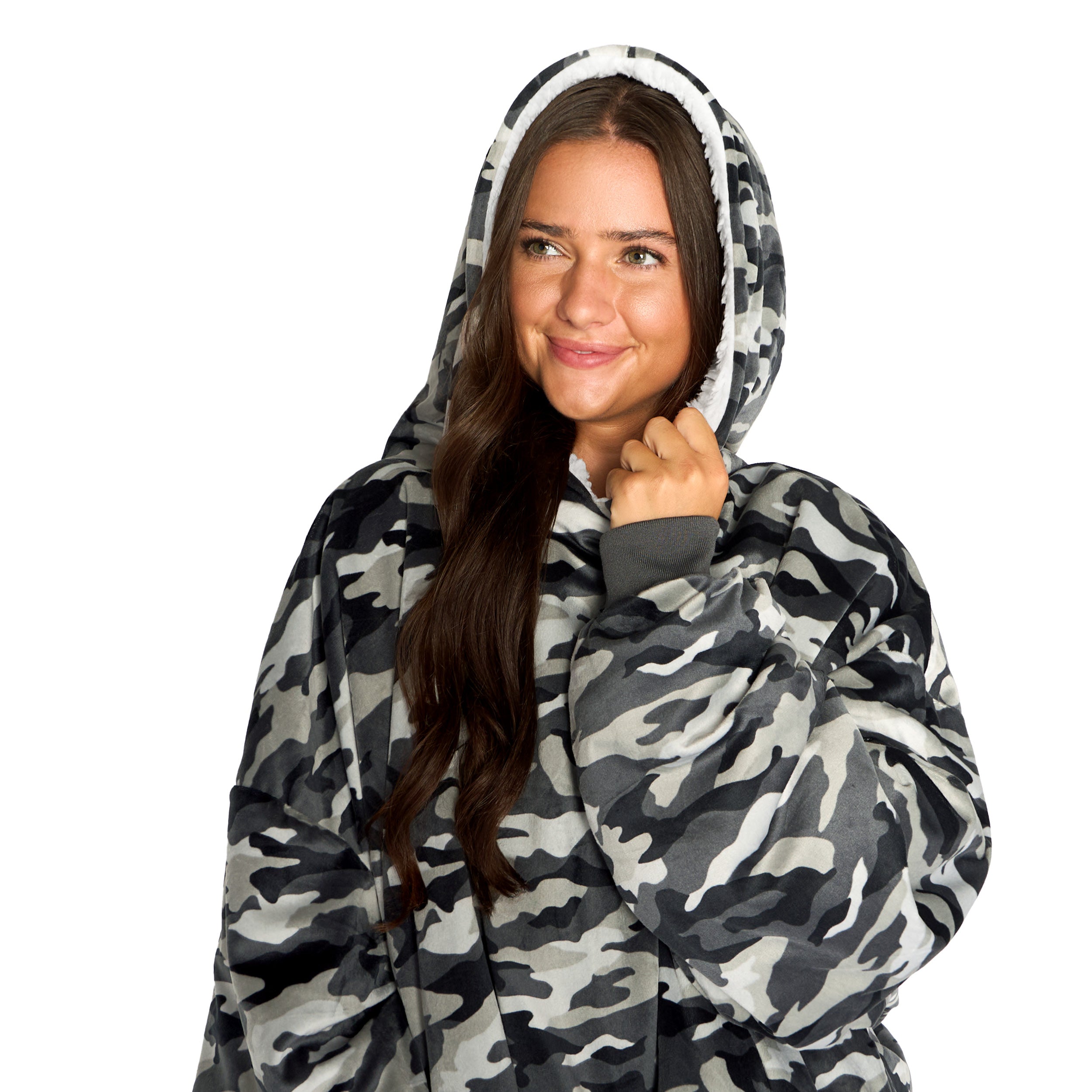 An adult with a hooded wearable blanket on