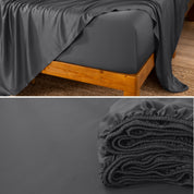 Bamboo fitted sheet on a wooden bed with a close-up of the folded sheet below.