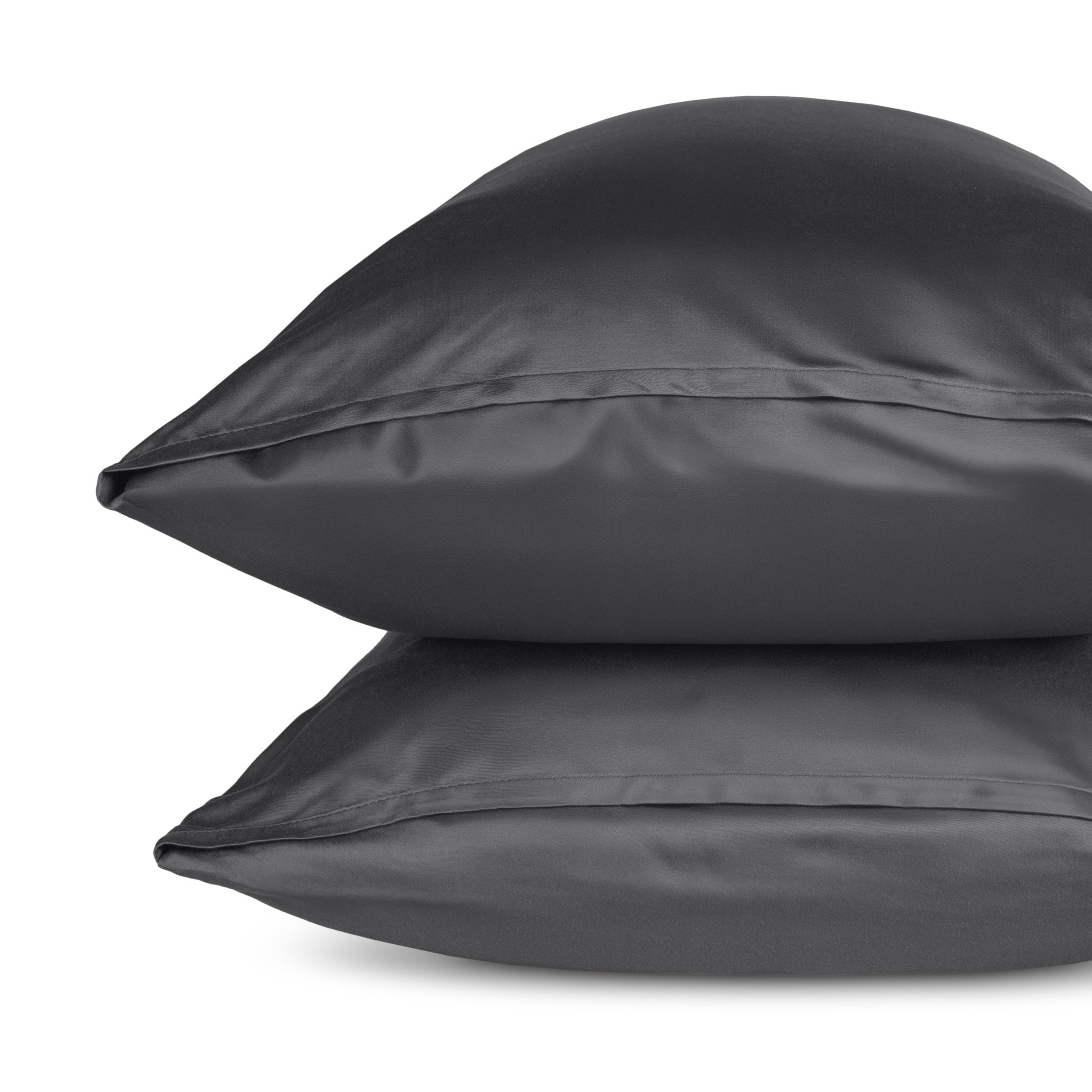 Two pillows with pillowcases stacked on a white background