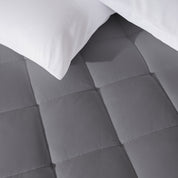 Close up of a cotton top mattress pad with pillows from above.