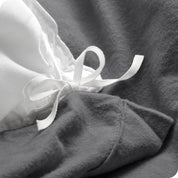 A folded stack of a flannel duvet cover with two pillows on top.