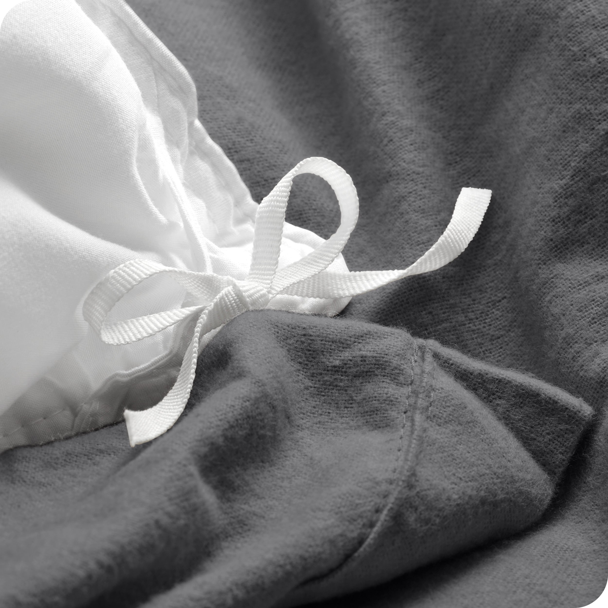 A folded stack of a flannel duvet cover with two pillows on top.