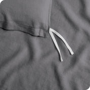 Close up of cloth tie straps for attaching duvet insert to inside of duvet cover