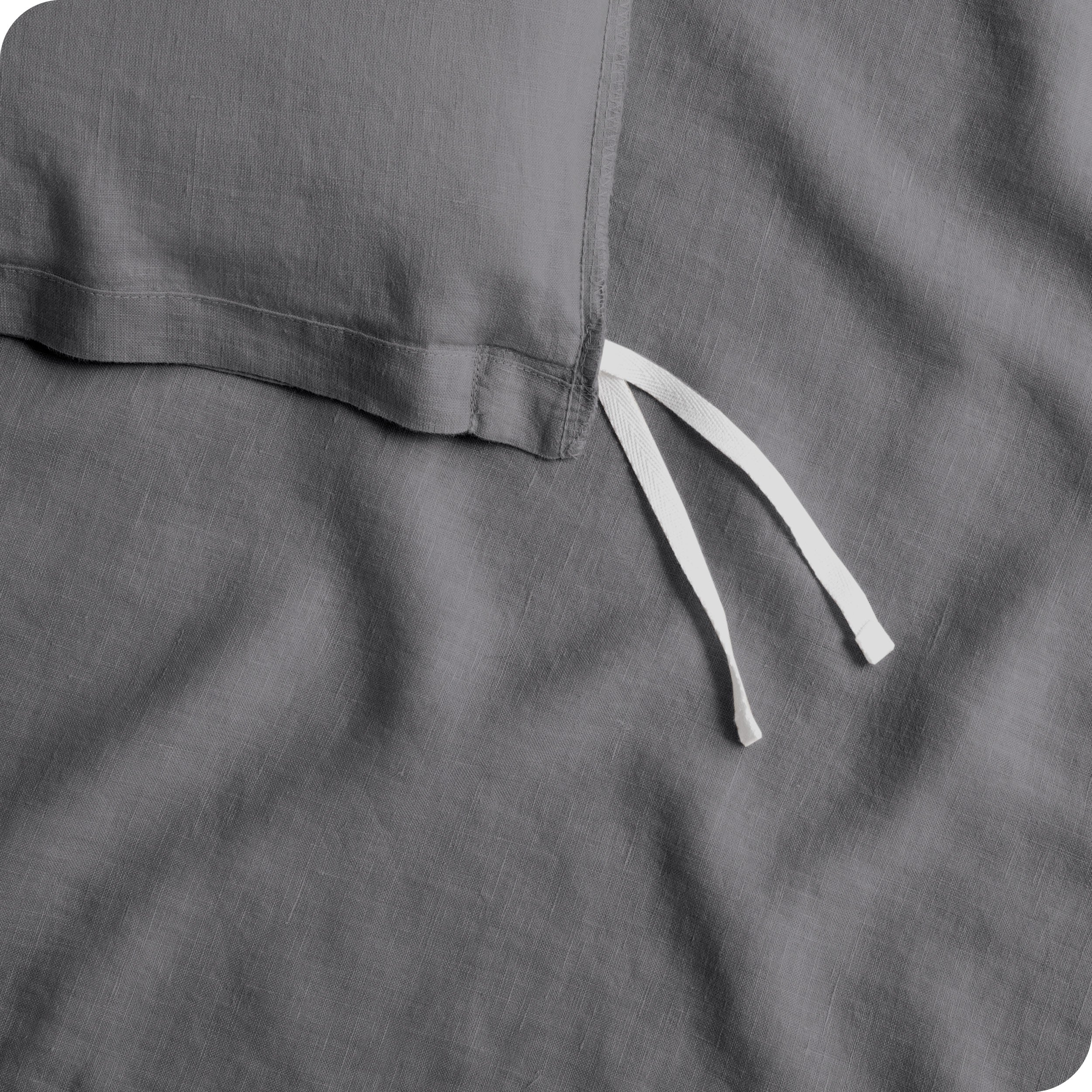 Close up of cloth tie straps for attaching duvet insert to inside of duvet cover