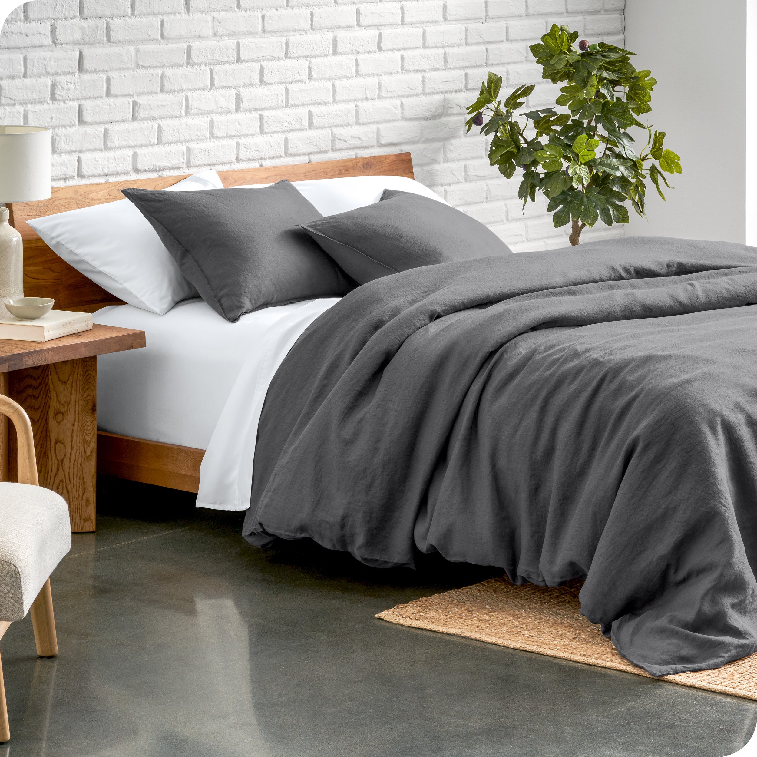 Relaxing room scene showing soft white linen duvet cover set laid out over the bed
