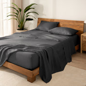 Wooden bed frame with  linen sheets on the mattress