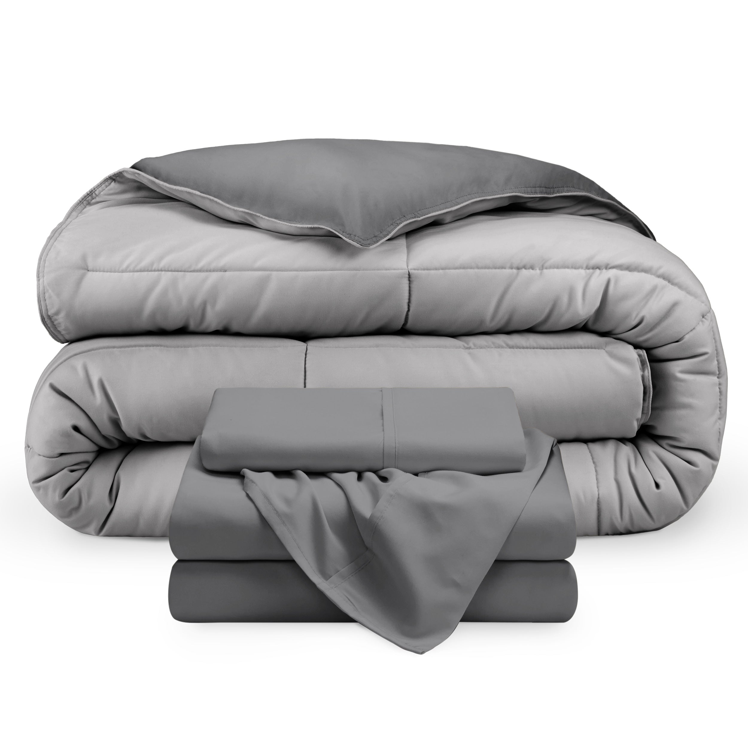 A reversible microfiber comforter and a coordinating sheet set folded and stacked 
