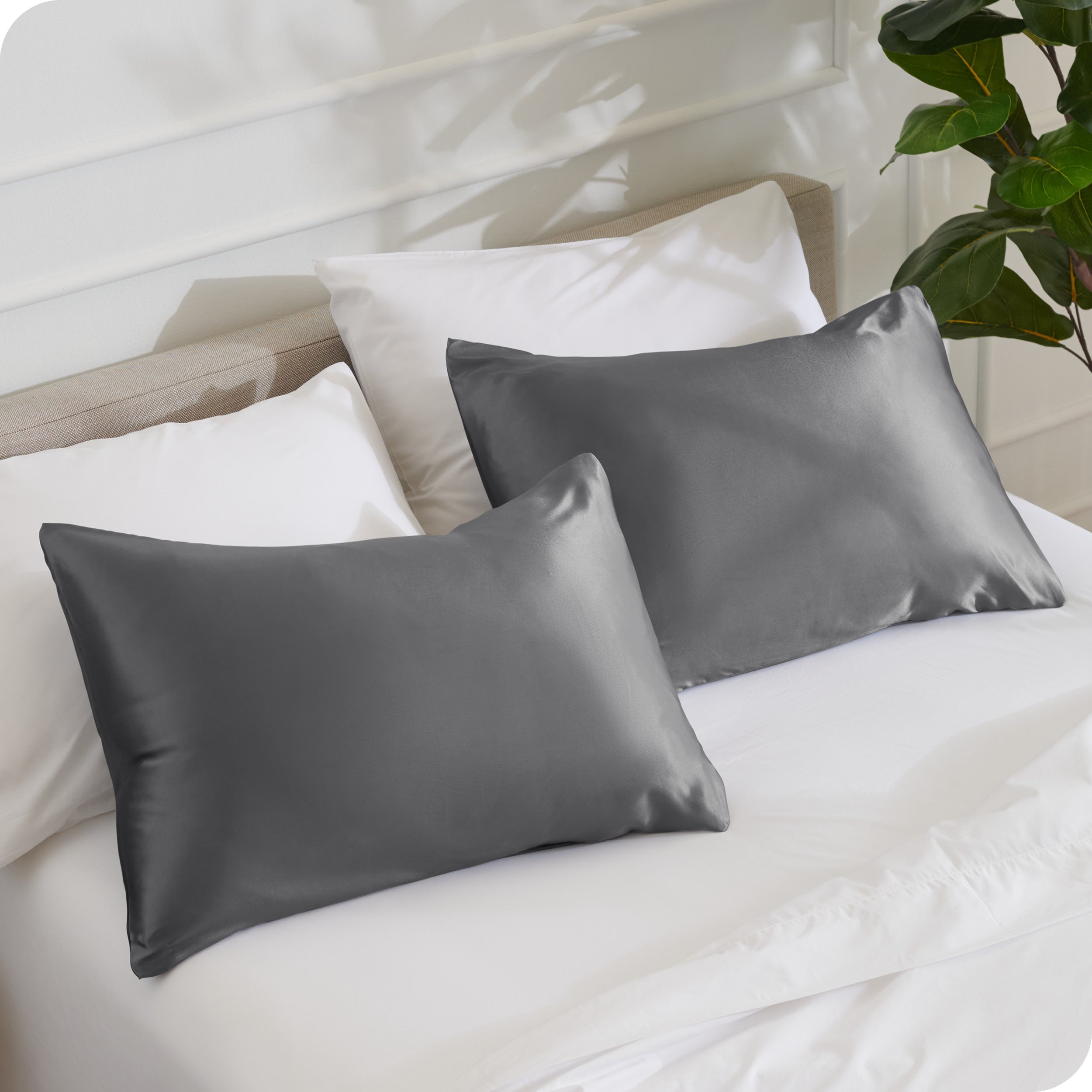 2 pillows with silk pillowcases on a bed