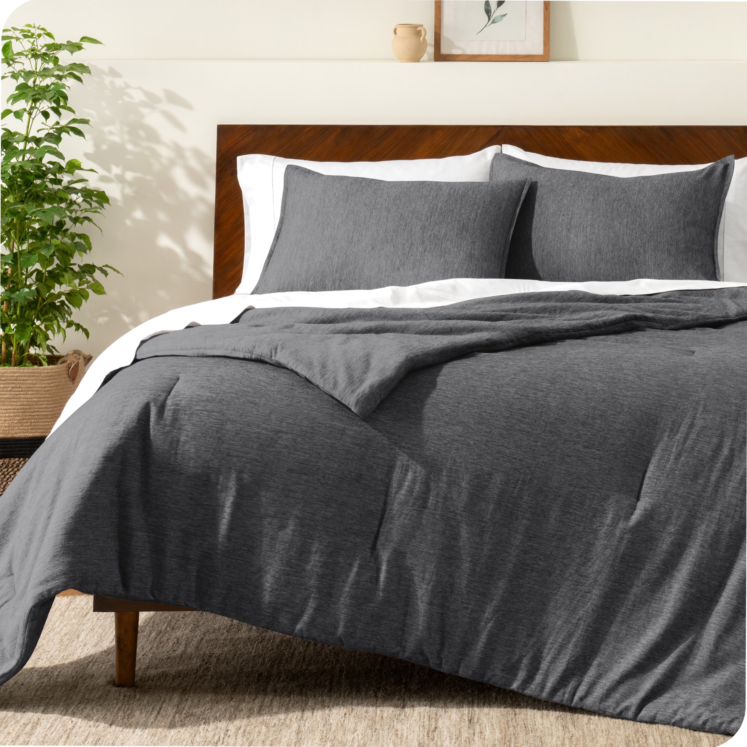 A modern bed with a down alternative comforter set on it
