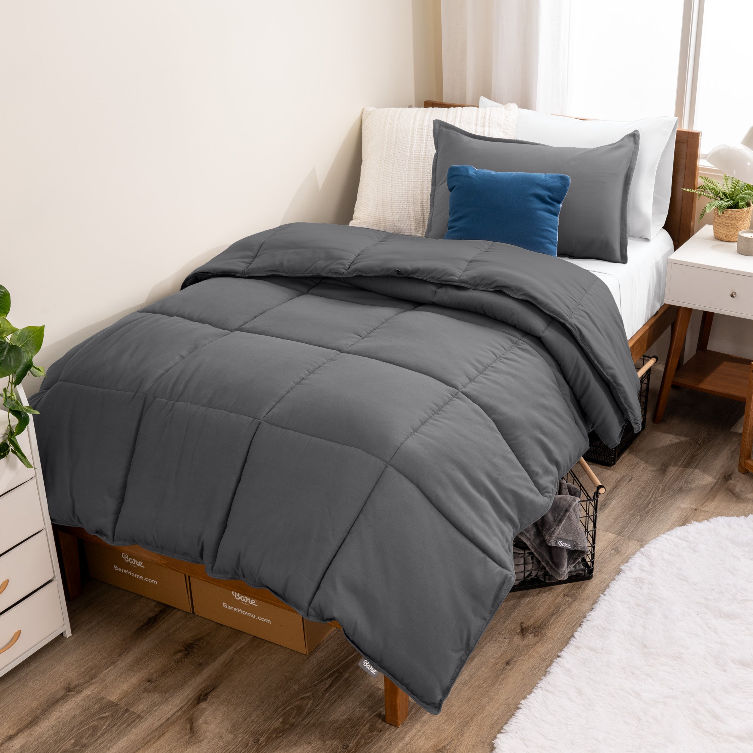 A modern bed with a down alternative comforter set on it