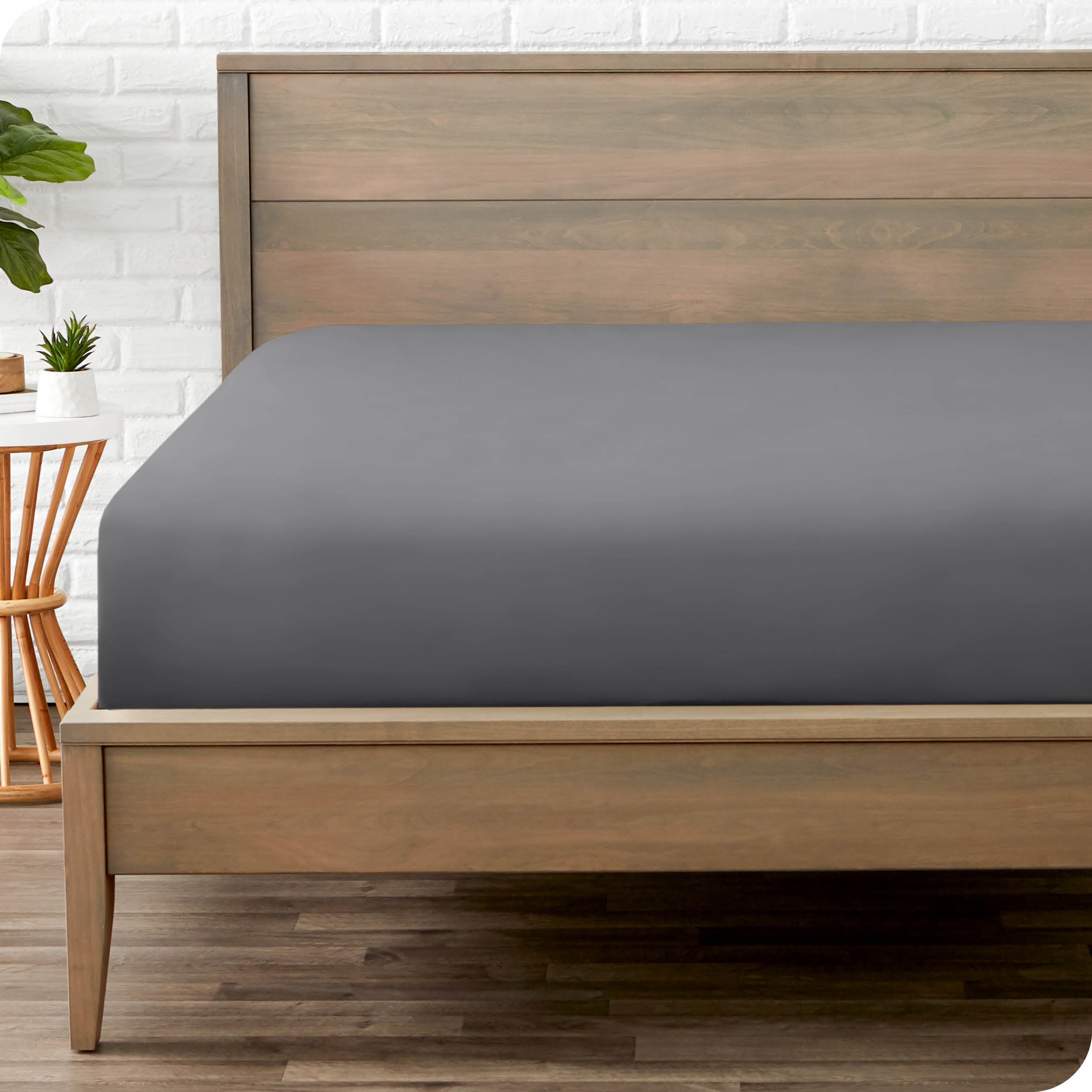 End of bed view with fitted sheet made on the mattress of a modern bed. 