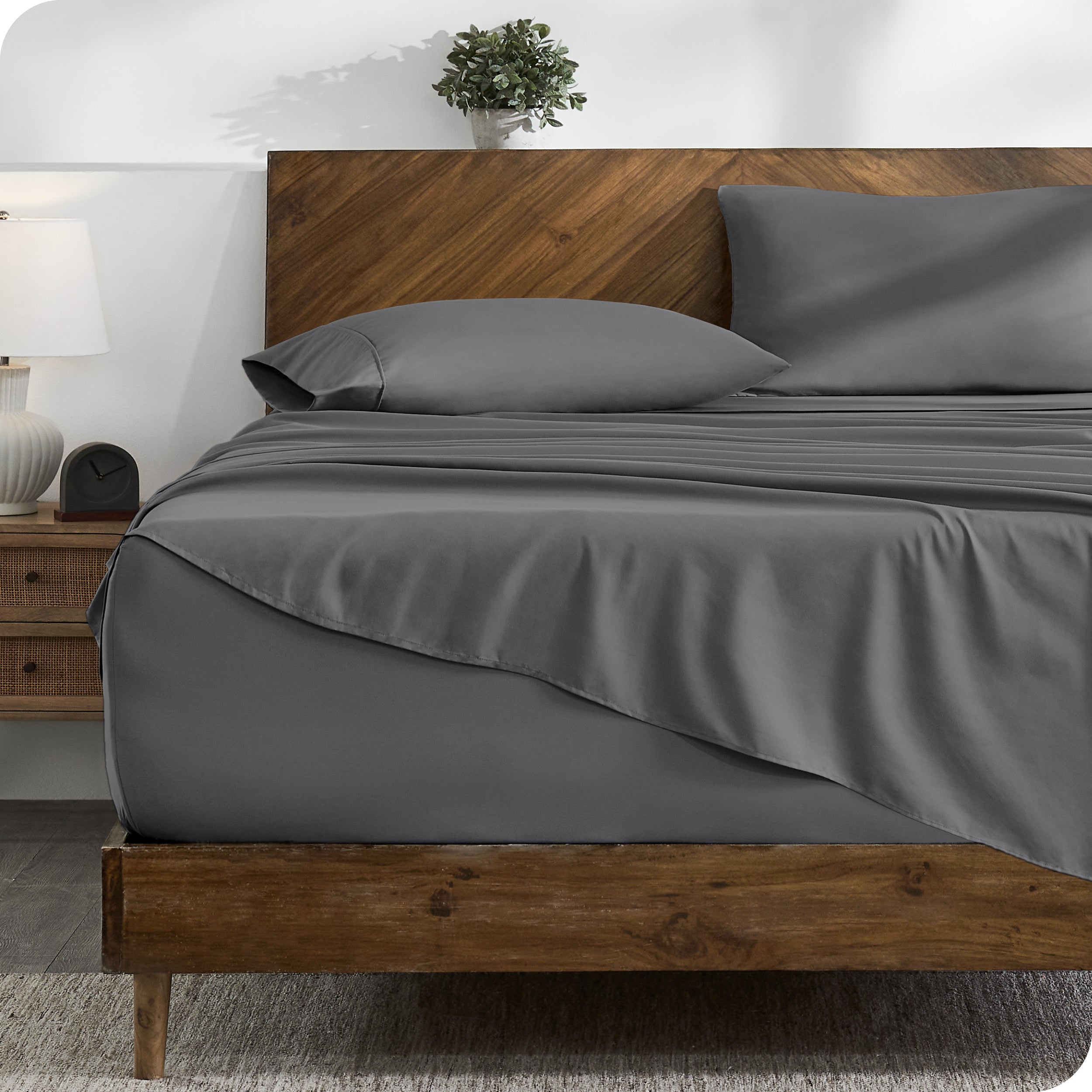 A cozy bedroom with a bed covered in soft microfiber sheets

