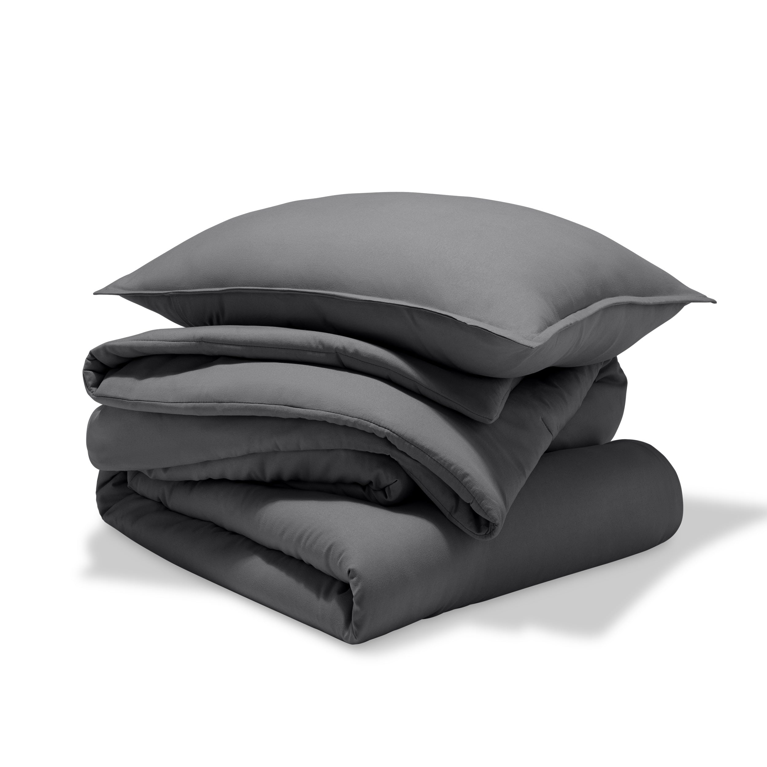 A comforter folded with a matching pillow sham stacked on top