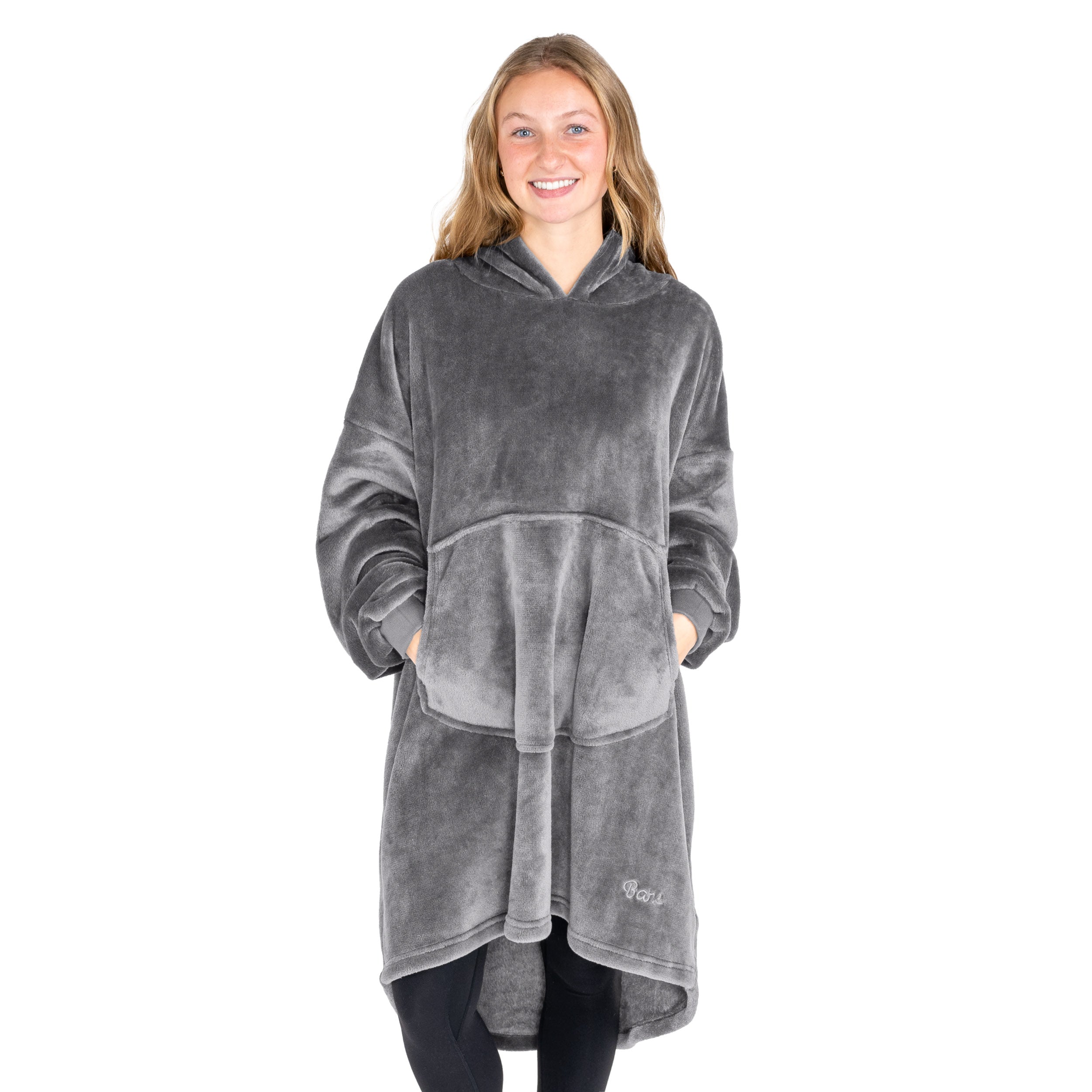 An adult with microplush wearable blanket on