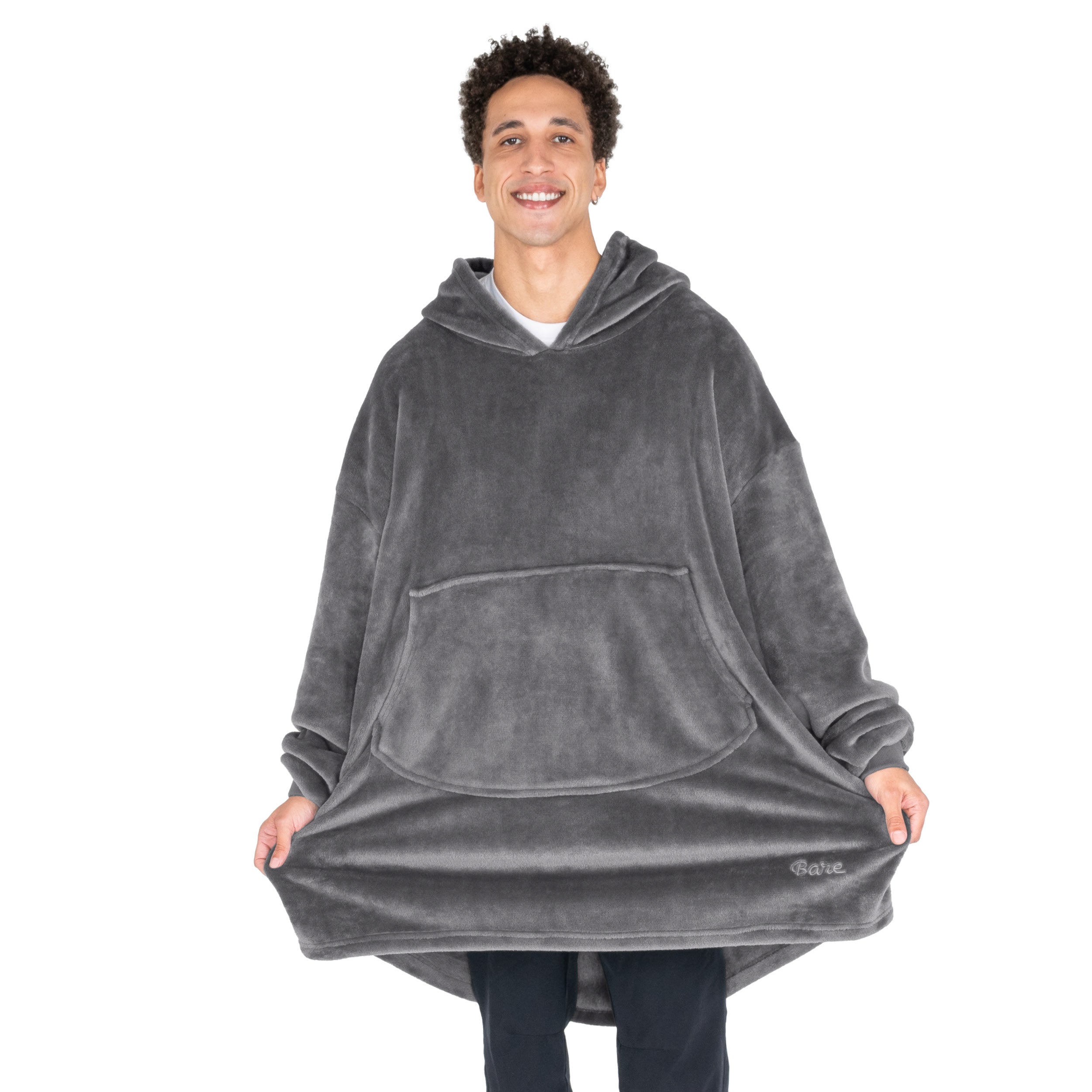 An adult with microplush wearable blanket on