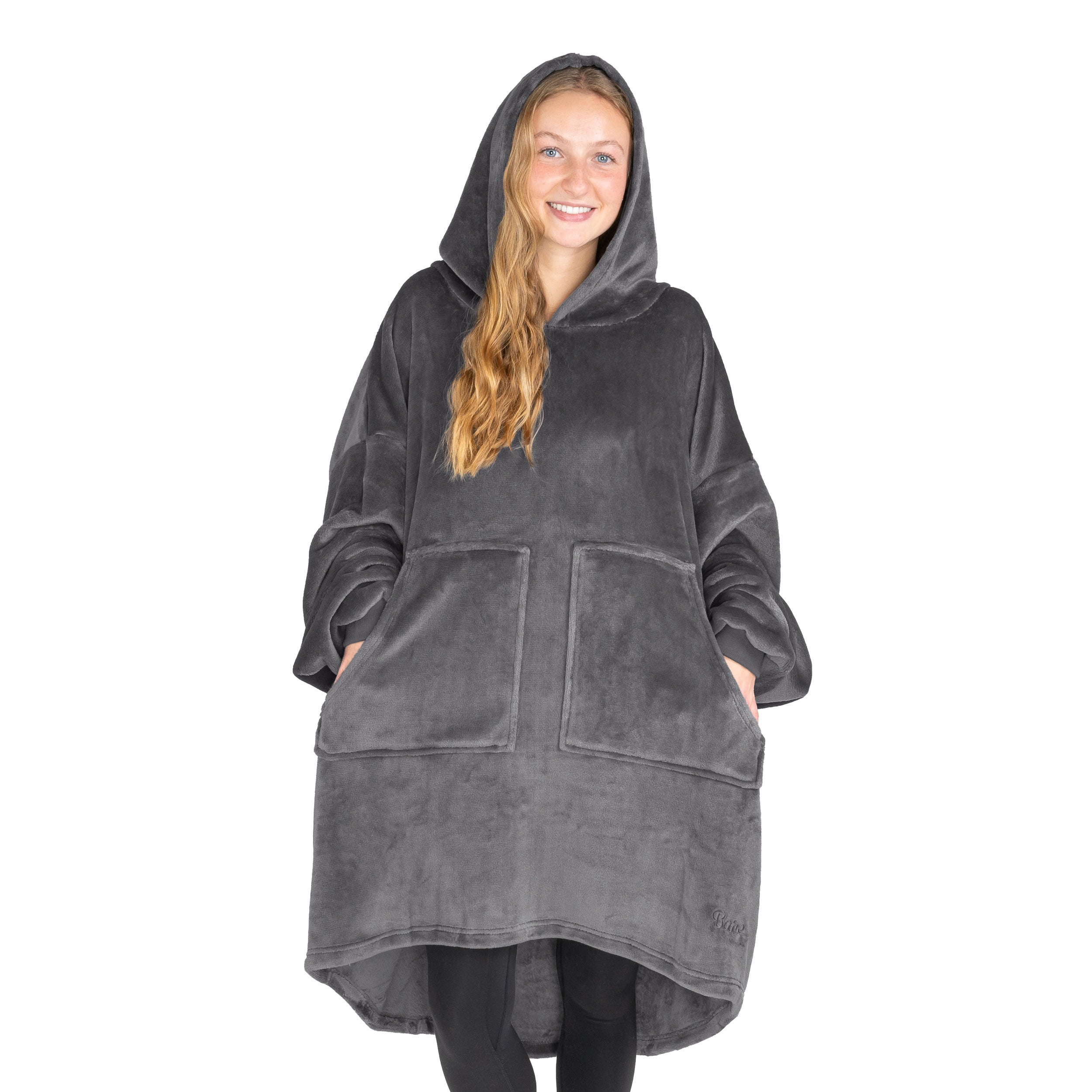 An adult with microplush wearable blanket on