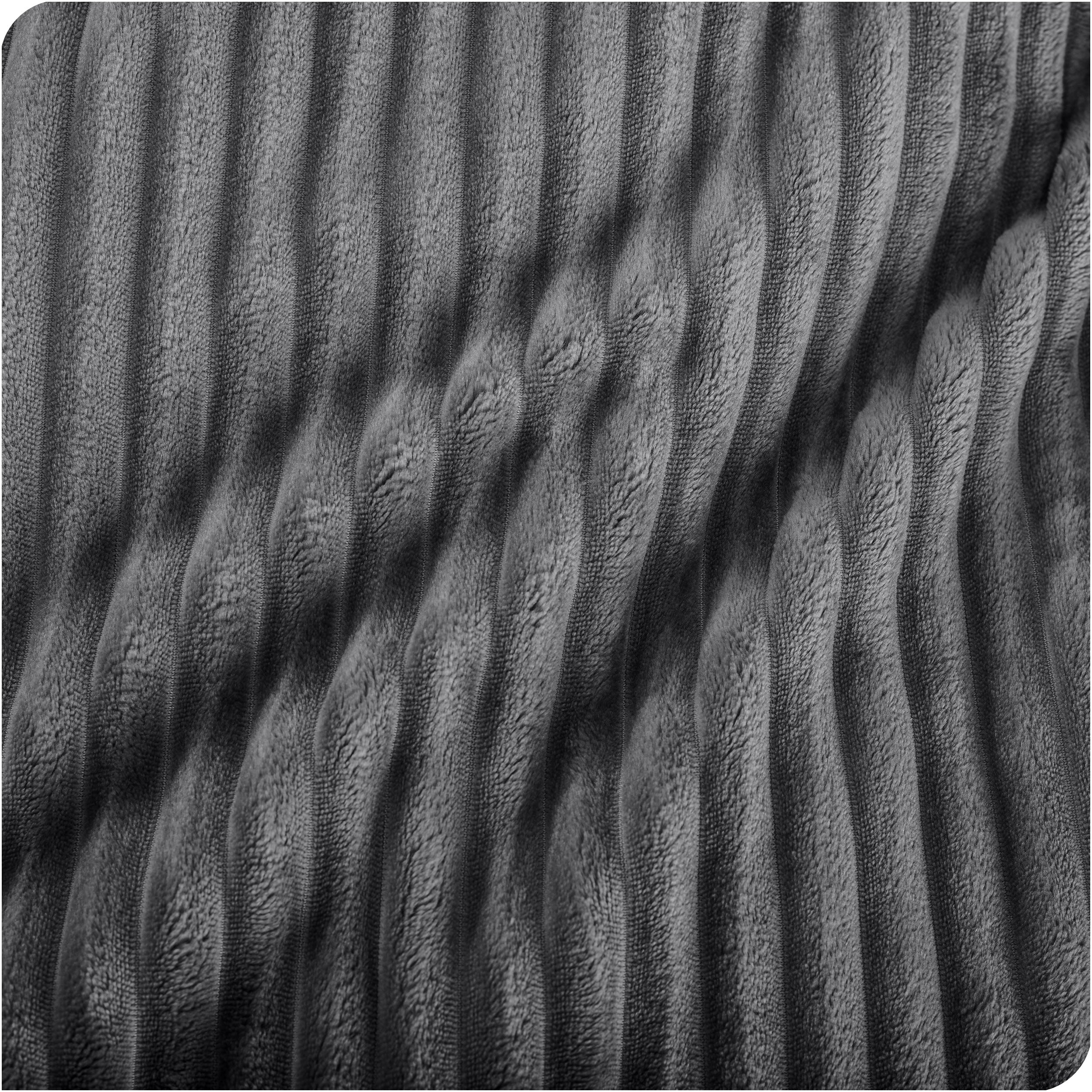 Close up of a ribbed microplush blanket showing the texture