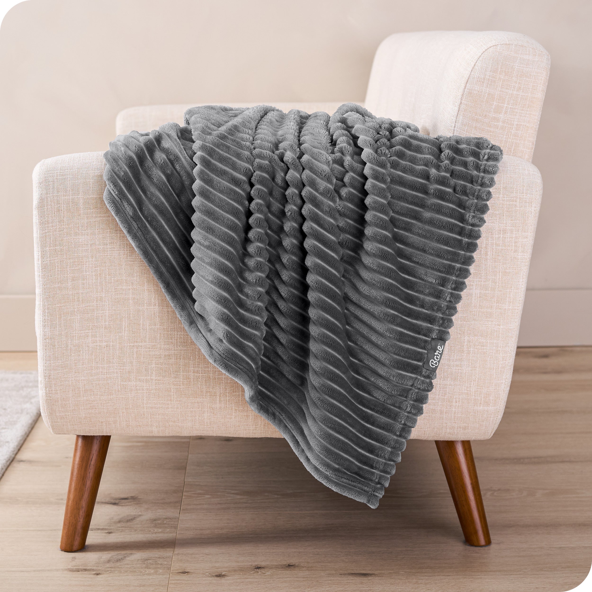 A blanket is draped over the arm of a small chair