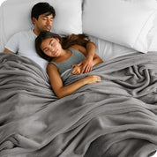 A couple sleeping while covered with a microplush blanket