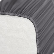A mattress pad wrapped around the side and back of a mattress