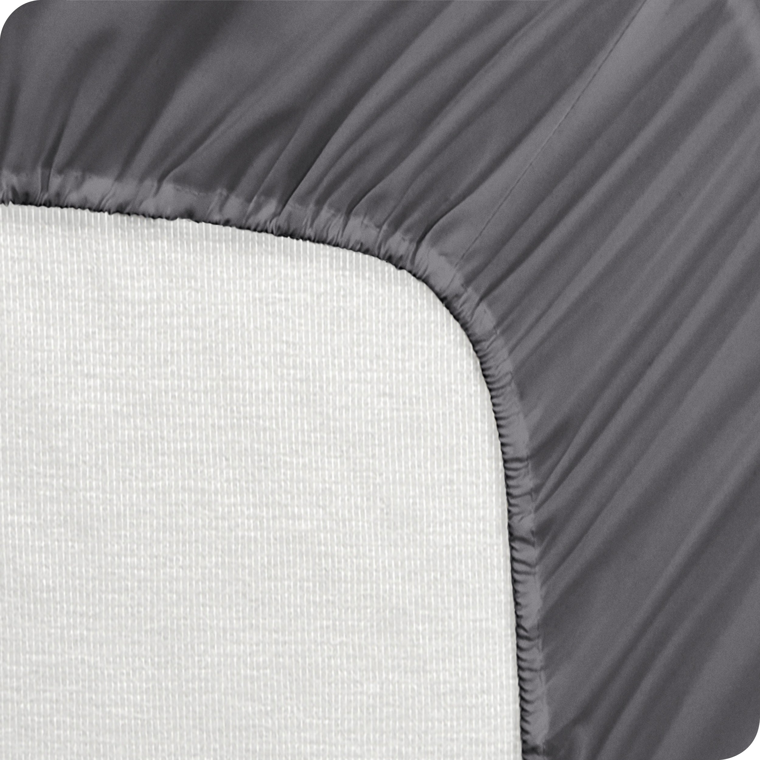 A mattress pad wrapped around the side and back of a mattress