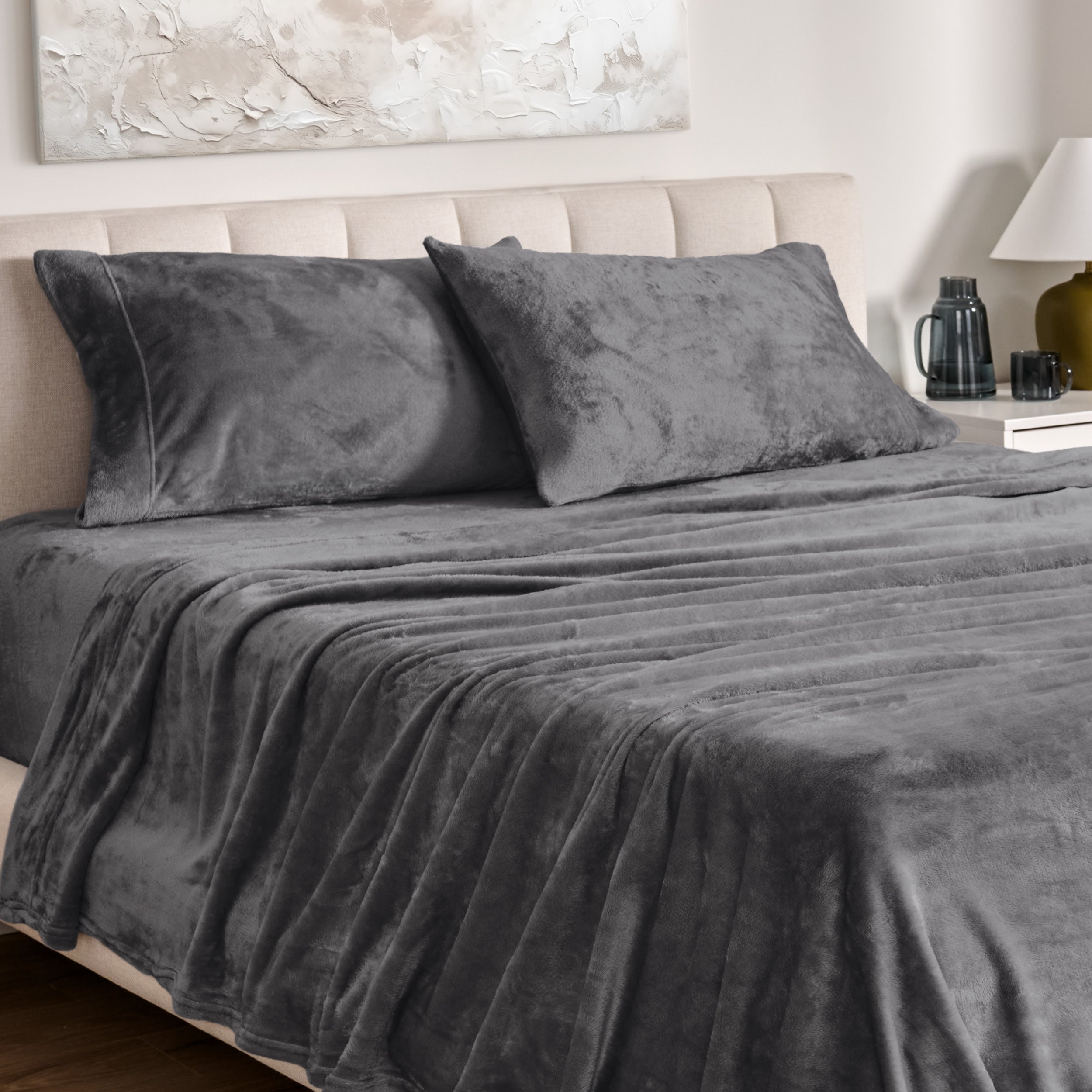 Microplush bed sheets and pillowcases on a bed with a neutral headboard and decor.