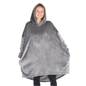 A woman standing with a wearable blanket on